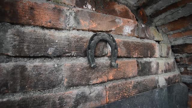 Horseshoe hanged on a old brick wall horizontal video