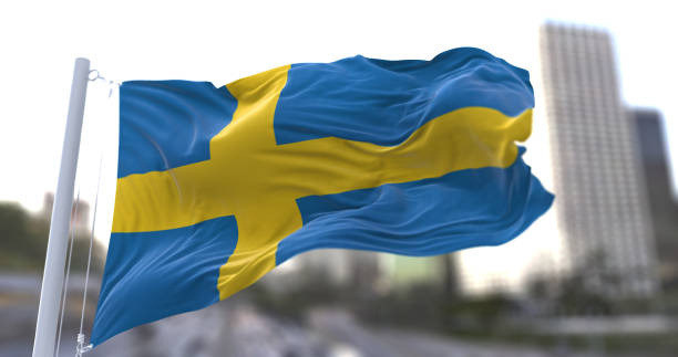 государственный флаг швеции развевается на ветру. - day sky swedish flag banner стоковые фото и изображения