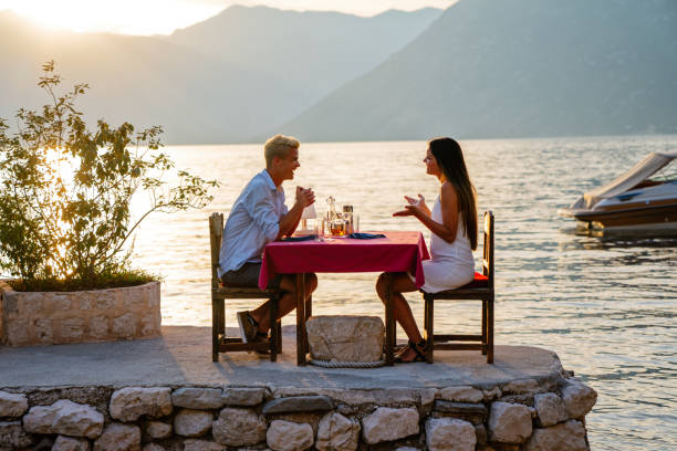 istock Couple in love drinking champagne wine on romantic dinner at sunset on the beach 1679960366