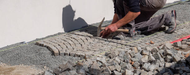 istock Workers pave an old cobblestone path in the old town 1679961408
