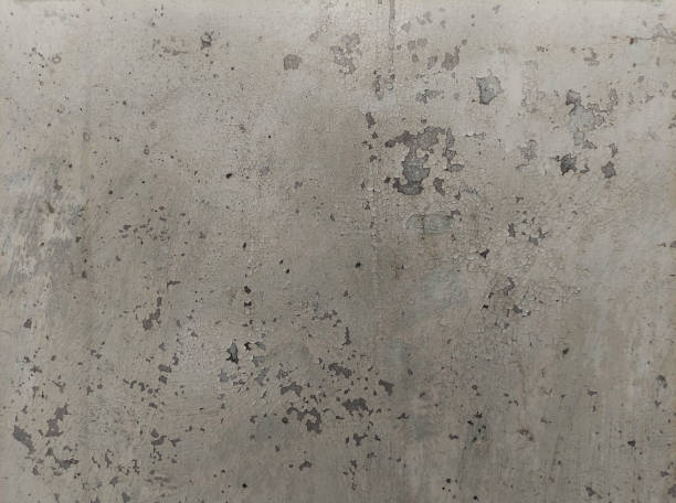 istock Concrete gray wall with cracks and pieces of falling off paint 1679962985