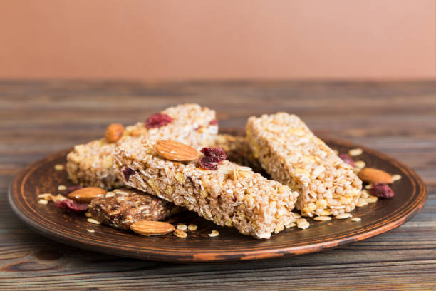 istock Various granola bars on table background. Cereal granola bars. Superfood breakfast bars with oats, nuts and berries, close up. Superfood concept 1679963539