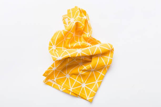 istock top view with yellow empty kitchen napkin isolated on table background. Folded cloth for mockup with copy space, Flat lay. Minimal style 1679964112