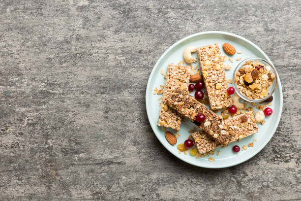 istock Various granola bars on table background. Cereal granola bars. Superfood breakfast bars with oats, nuts and berries, close up. Superfood concept 1679965213