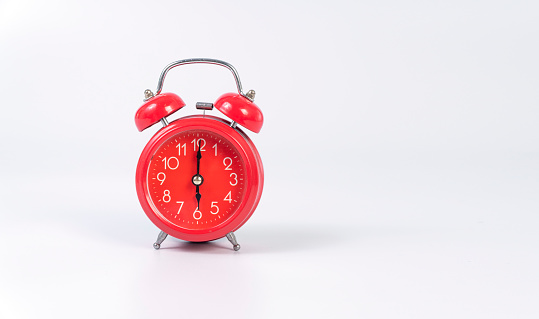 Red alarm-clock symbol time wake up over isolated white background. Analog red alarm clock on six oâclock morning waking vintage classic bell on white background.History, future, Countdown object time