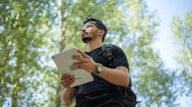 istock Researcher man doing environmental research with digital tablet in forest 1679994403