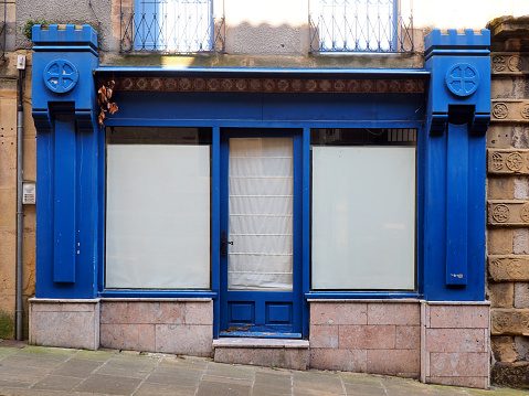 facade of an old abandoned shop in the historic center of the old town of Hondarribia in the heart of the beautiful and green Basque country, in the North of Spain, near the Atlantic coast.