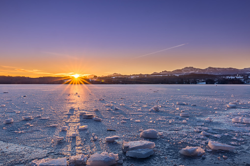Frozen Lake with Ice Floes in Winter Landscape during Sunrise, Bavaria, Germany, Europe