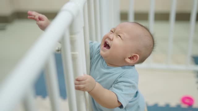 Happy children playing in the playpen