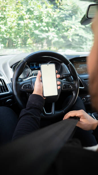 istock Man looking at his smartphone before going on a trip in the car , mock up screen 1680012959