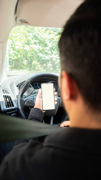 istock Man looking at his smartphone before going on a trip in the car , mock up screen 1680013508