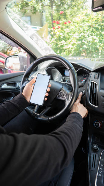 istock Man looking at his smartphone before going on a trip in the car , mock up screen 1680014018