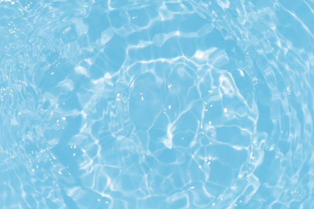 istock Blue water with ripples on the surface. Defocus blurred transparent blue colored clear calm water surface texture with splashes and bubbles. Water waves with shining pattern texture background. 1680017857