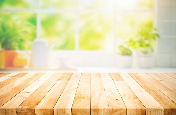 istock Selective focus.Wood table top on blur kitchen counter in morning background.For montage product display 1680025366