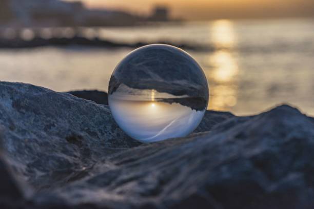 istock Sunset on the beach with crystal ball resting on the rock. Spain. 1680036088