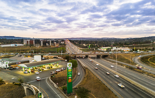 BP filling station on the N1 highway offramp to Beyers Naude Drive in Johannesburg at sunset and at peak hour traffic.
