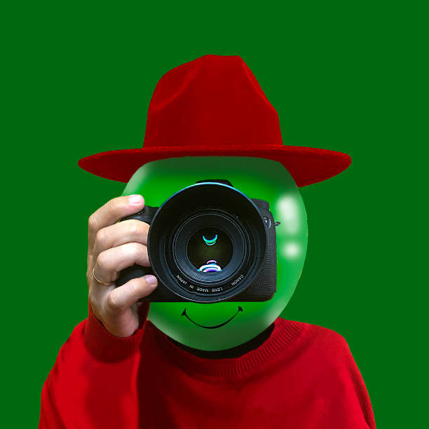 Photographer with a camera on his head. Isolated on green background