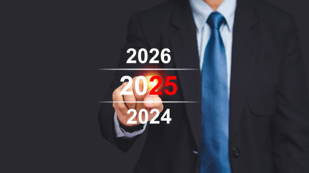 istock Business planning 2025. A businessman points to a digital calendar on a virtual screen while standing on a black background 1680098546