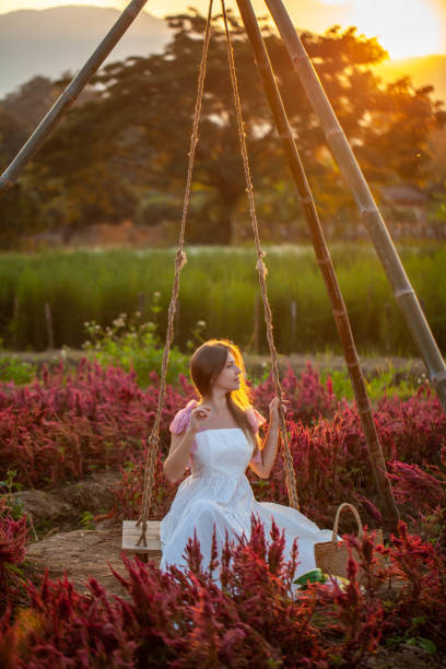 istock Beautiful woman amidst the flowered park 1680114974