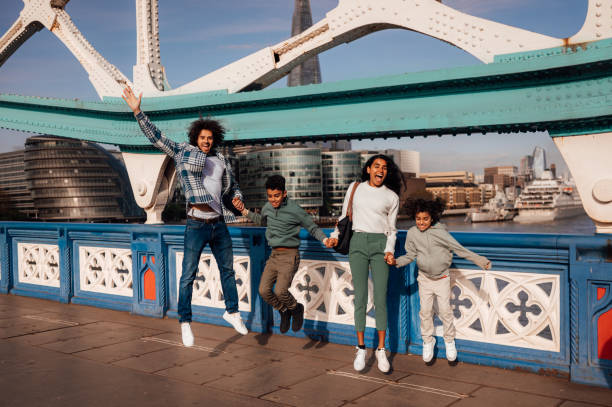 istock A family joyfully skip and jump together while holding hands. 1680155458
