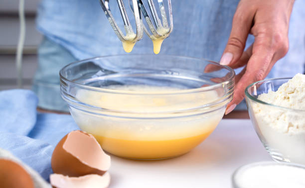 istock A young woman beats eggs with a mixer at the kitchen at home. Biscuit making process. Selective focus. 1680156003
