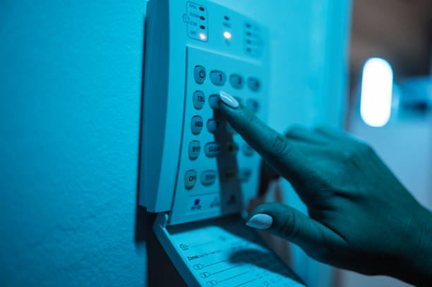 istock Woman setting up alarm and video camera at home 1680158641