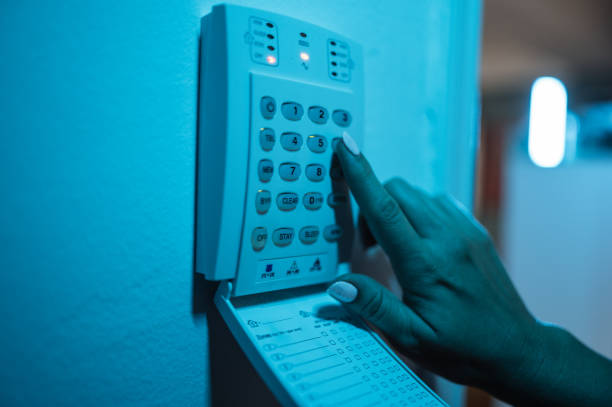 istock Woman setting up alarm and video camera at home 1680158652