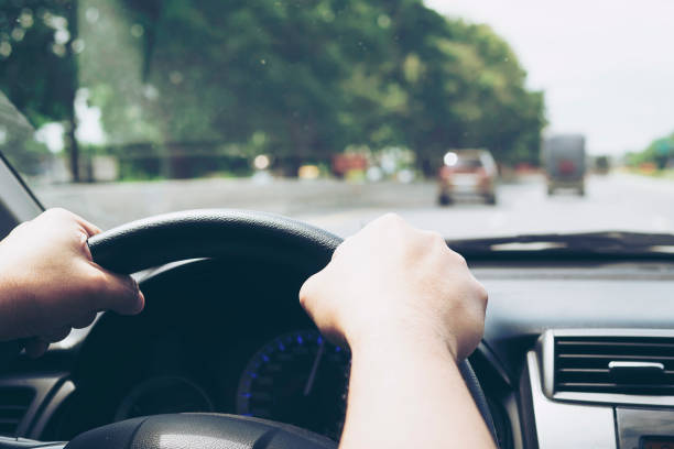 istock Close up of a man driving car using two hands 1680179532