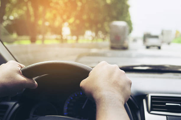 istock Close up of a man driving car using two hands 1680180063
