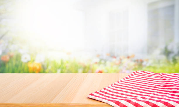 istock Select tive focus.Empty wood table top on blur abstract garden flower with cozy house background. 1680197104