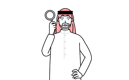 Senior Muslim Man looking through magnifying glasses