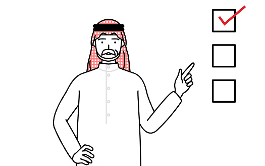 Senior Muslim Man pointing to a checklist.