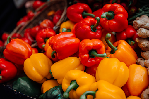 Close up of red and yellow bell peppers on a fruit and vegetable stall