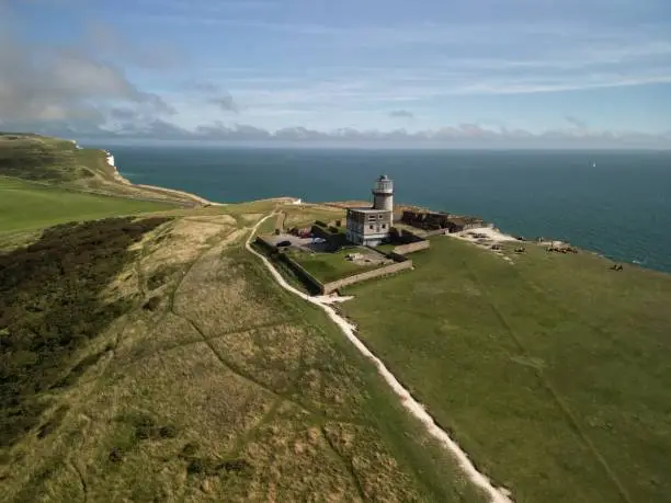 An aerial view of Belle Tout lighthouse in Southdowns, UK on a sunny day