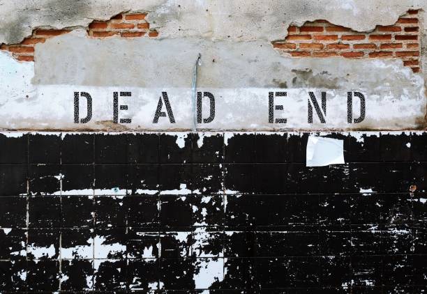 istock Old grunge ruined brick tiled wall with text inscription DEAD END, a road or a path with no exit at one end or situation with no hope or no way out 1680226910