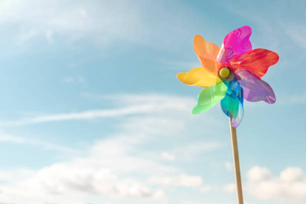 Pinwheel or windmill summer beach background concept for vacation, renewable energy or recreation