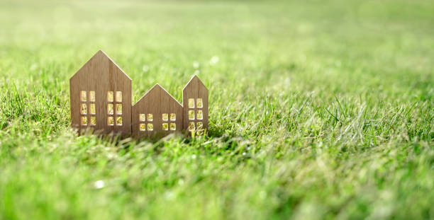 Eco wooden model house in empty field at sunset Green ecological house in empty field at sunset concept for construction and real estate house uk countryside stock pictures, royalty-free photos & images