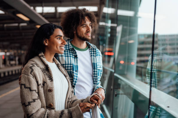 istock A couple look out at the view while waiting for a train. 1680238784