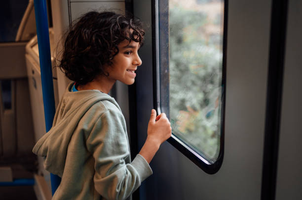 istock A young boy looks out of a train window. 1680241729