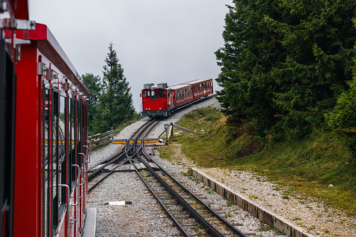 Cog railway train going to Schafberg summit. Transport in Alps mountain in Salzburger land. Tourism in Austria