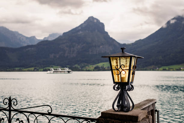 Lantern at Wolfgangsee lake, St. Wolfgang. Austrian Alps mountains. Transport ferry ship in distance on a lake