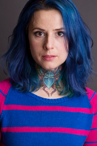 Portrait of the woman with blue hair and a throat tattoo