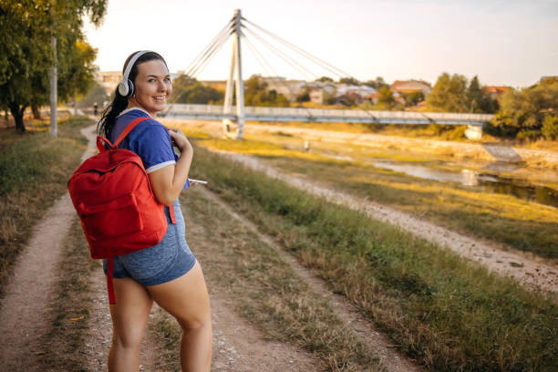 Woman living heathy lifestyle exercising on riverside in evening hours