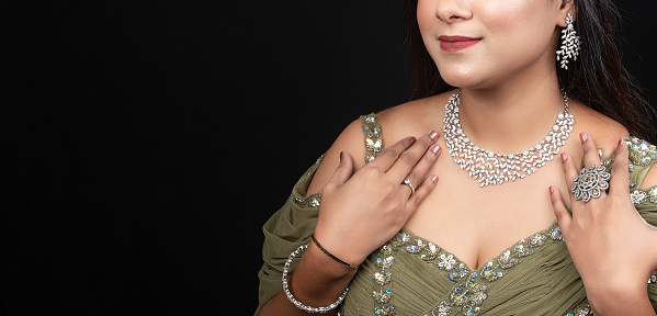 Fashion portrait of young beautiful woman with diamond jewelry , Beautiful woman with Diamond Necklace and earring with ring.  Concept of Fashion and beauty with Jewellery and accessories.