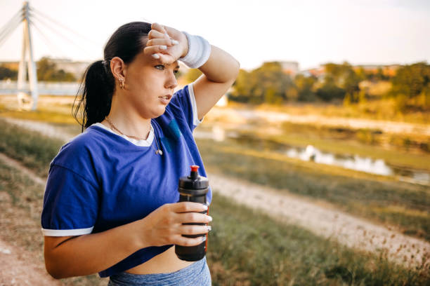 istock Young woman tired after exercising on riverbank 1680258347
