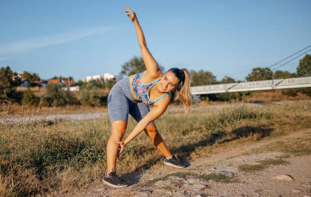 istock Young woman exercising on riverbank 1680259392