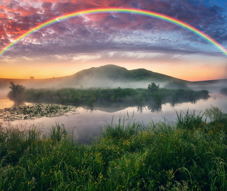 Landscape with a Rainbow on the River in Spring. colorful morning. nature of Ukraine