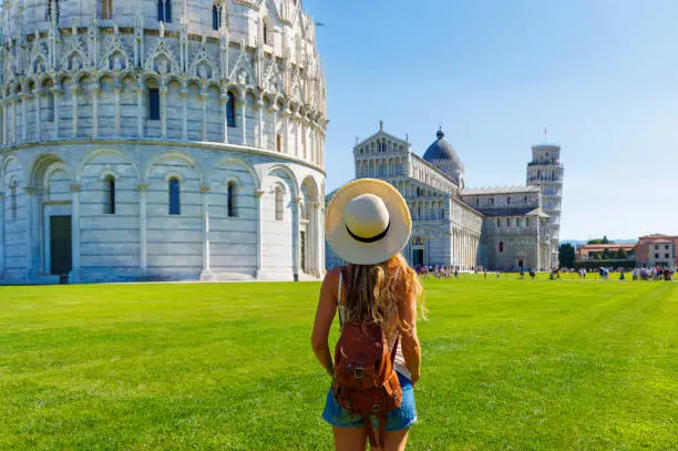 Happy traveler female in Italy, enjoying view of Pisa tower- Tour de pise