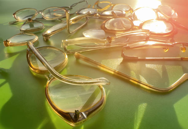 istock Glasses on a green background. Old vision glasses in a pile. 1680307300