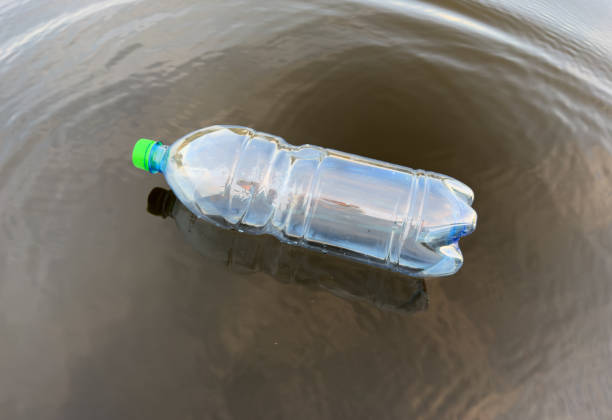 istock Plastic bottle garbage on sea shore. Collecting waste and garbage on beach. 1680311700